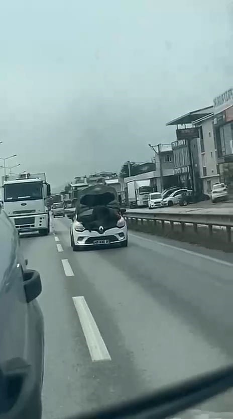 BURSA’DA BİR TAMİRCİNİN, SEYİR HALİNDEKİ OTOMOBİLİN KAPUTUNU AÇARAK ARAÇ ÜZERİNDE TAMİRAT YAPMASI GÖRENLERİ ŞAŞKINA ÇEVİRDİ. TEHLİKELİ YÖNTEMLE YAPILAN TAMİRAT, CEP TELEFONU KAMERASINA YANSIDI.